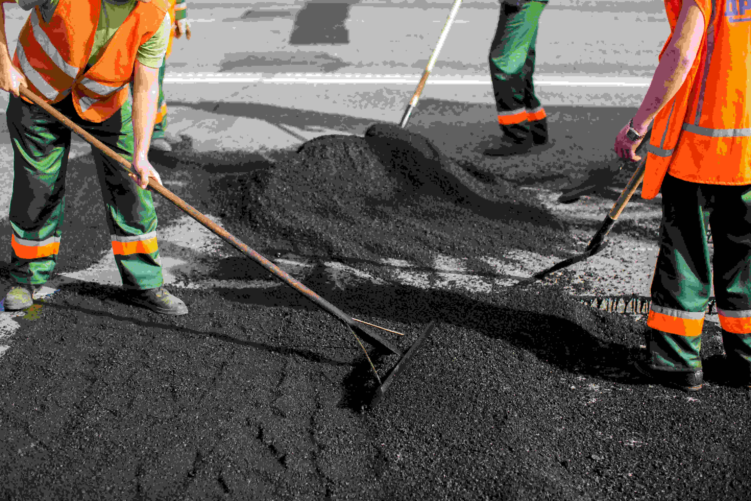 Asphalting paver machine during road construction, representing professional asphalt services and maintenance in Kennesaw