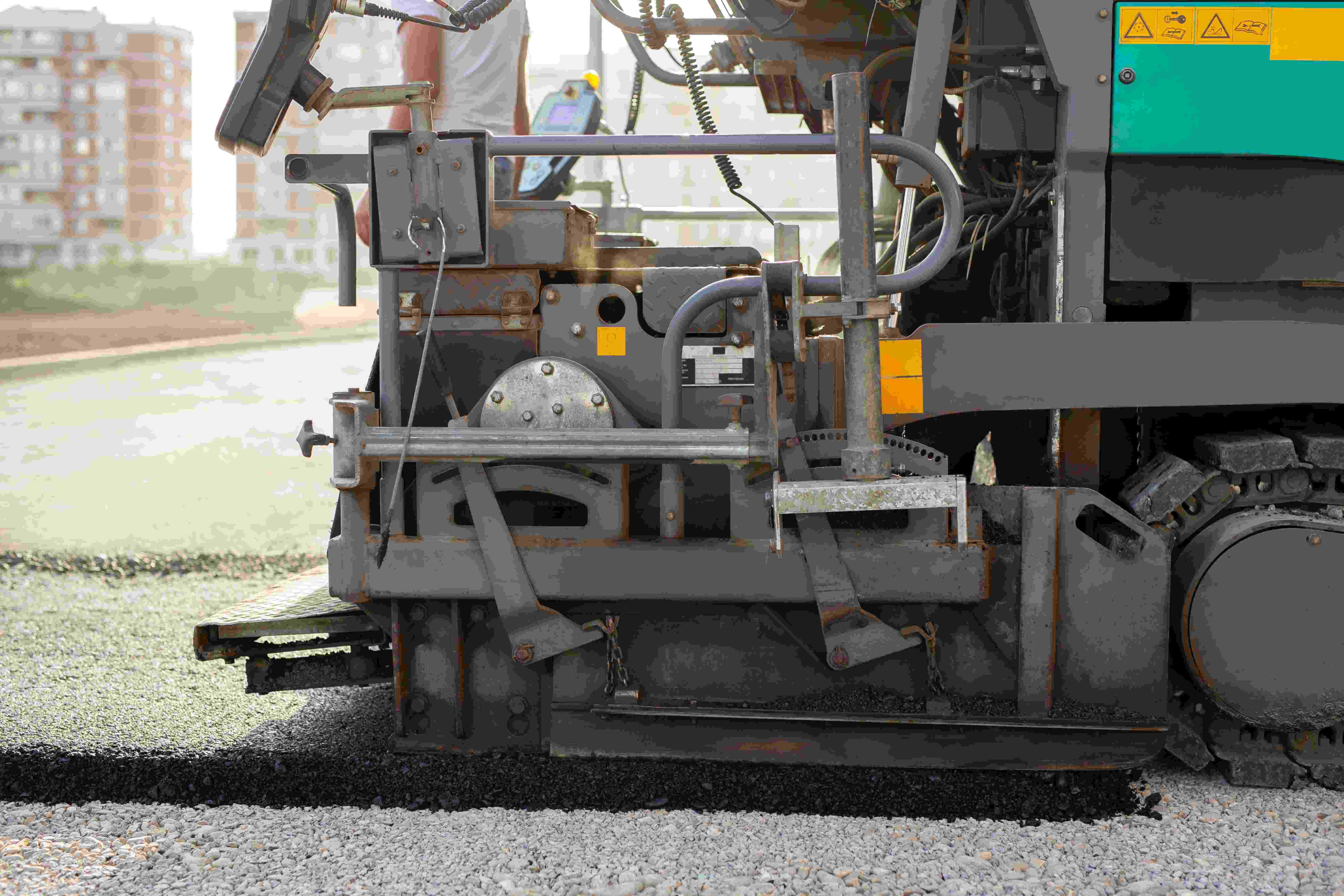 Asphalt spreader paver machine laying smooth pavement, showcasing expert asphalt paving services in Sandy Springs