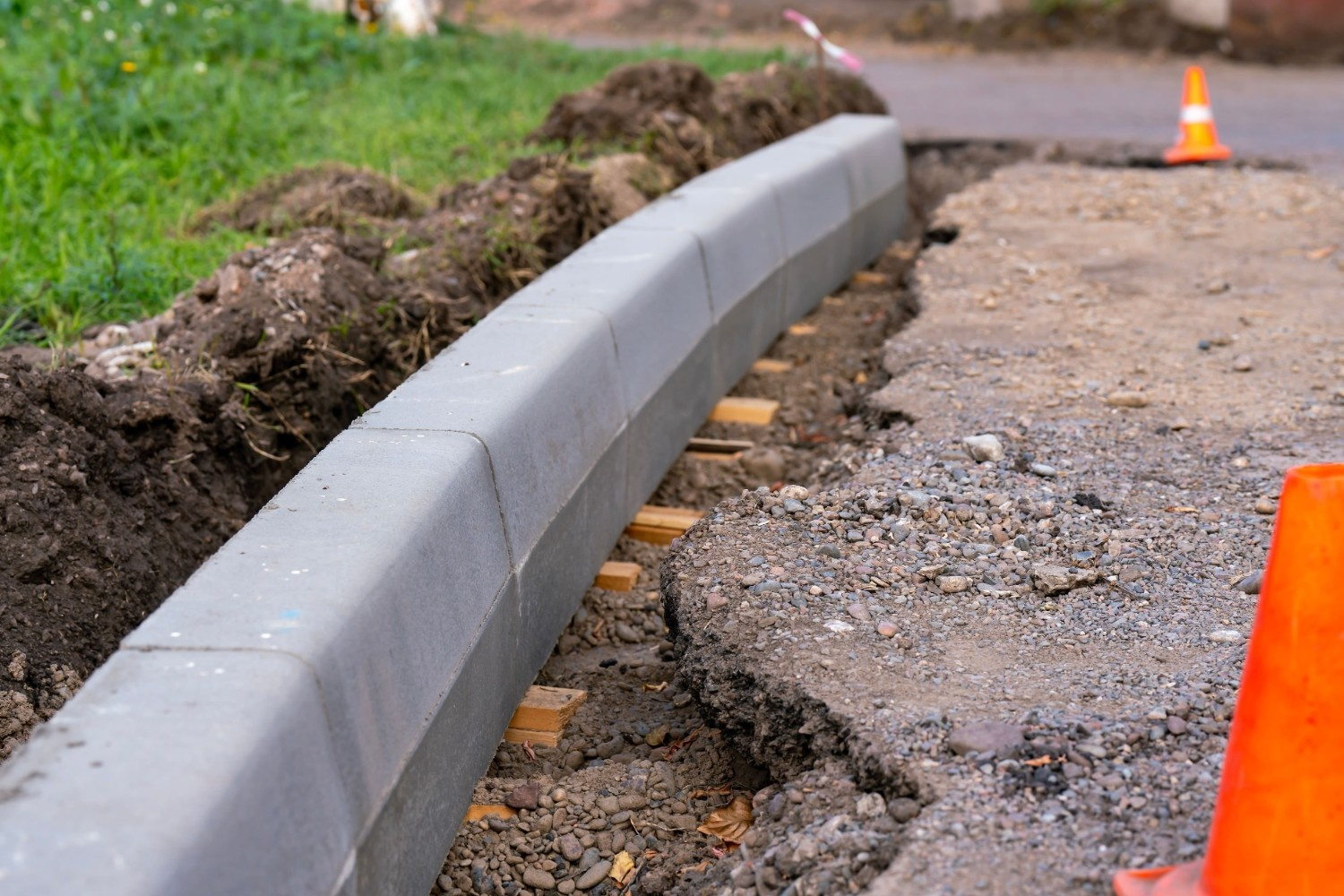 Workers installing new concrete curbs on a street as part of professional concrete installation services.