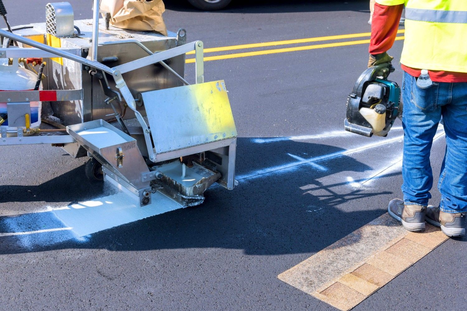 Pavement line striping service with crew applying fresh road markings for safer traffic flow.